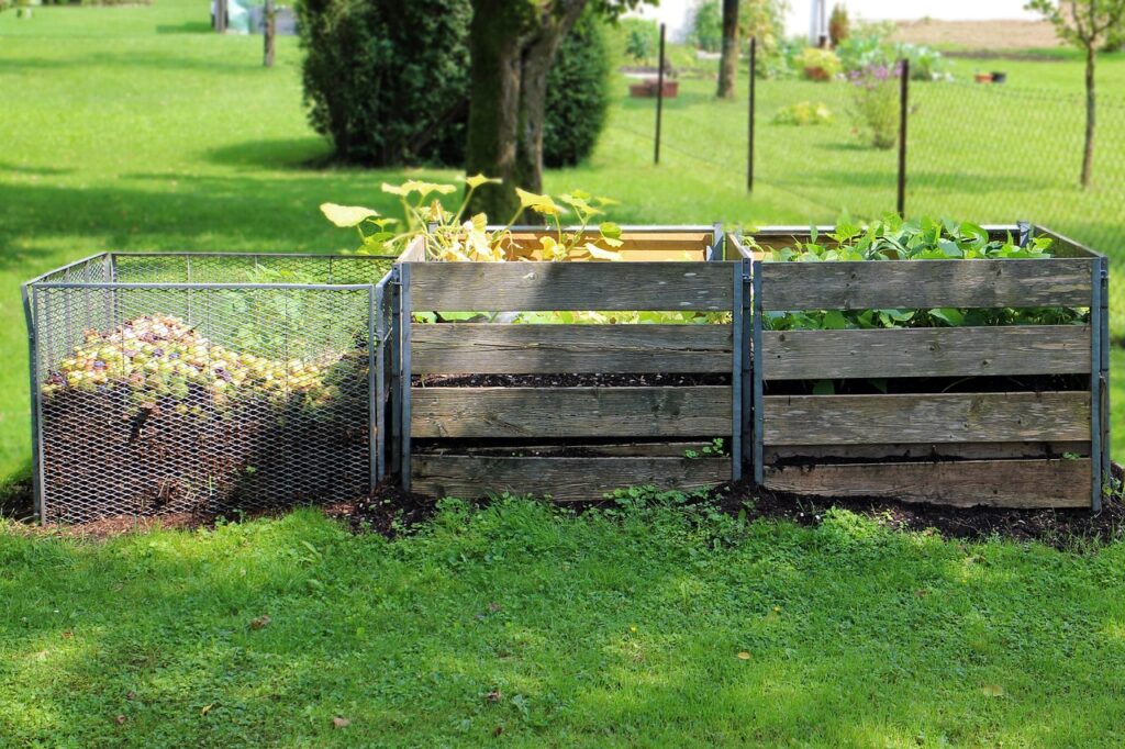 Compost bins with vegetable scraps in a home garden.